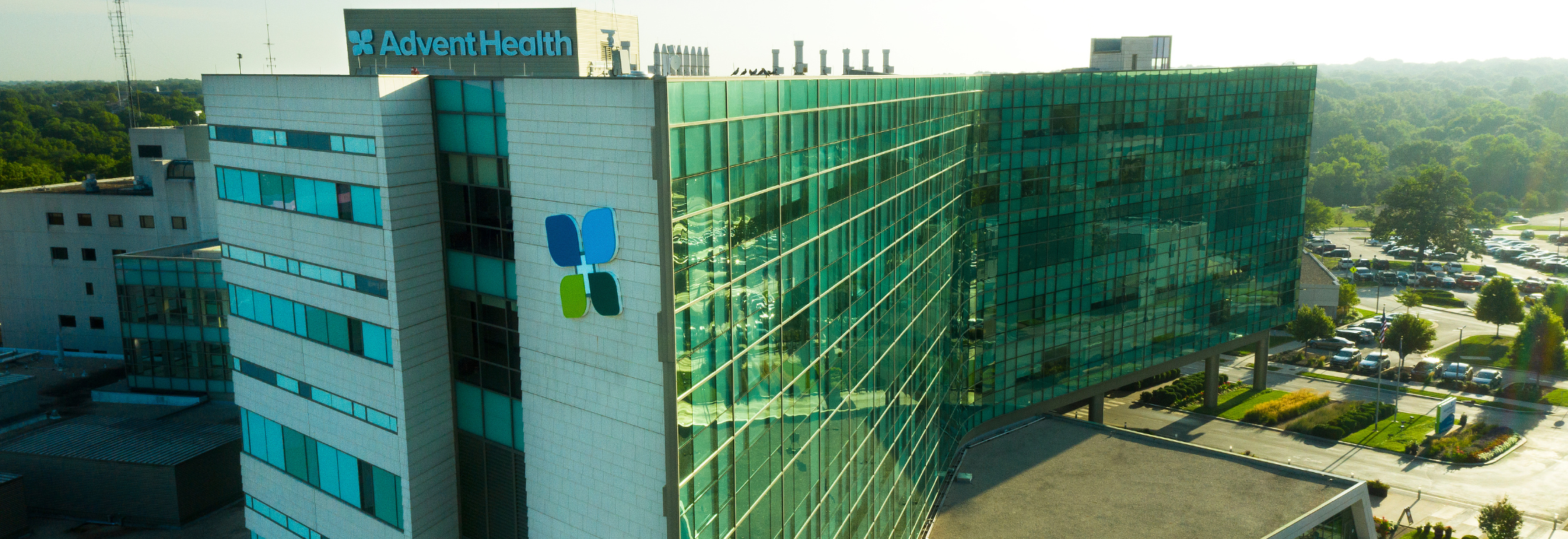 Three doctors having a discussion in a hospital hallway.